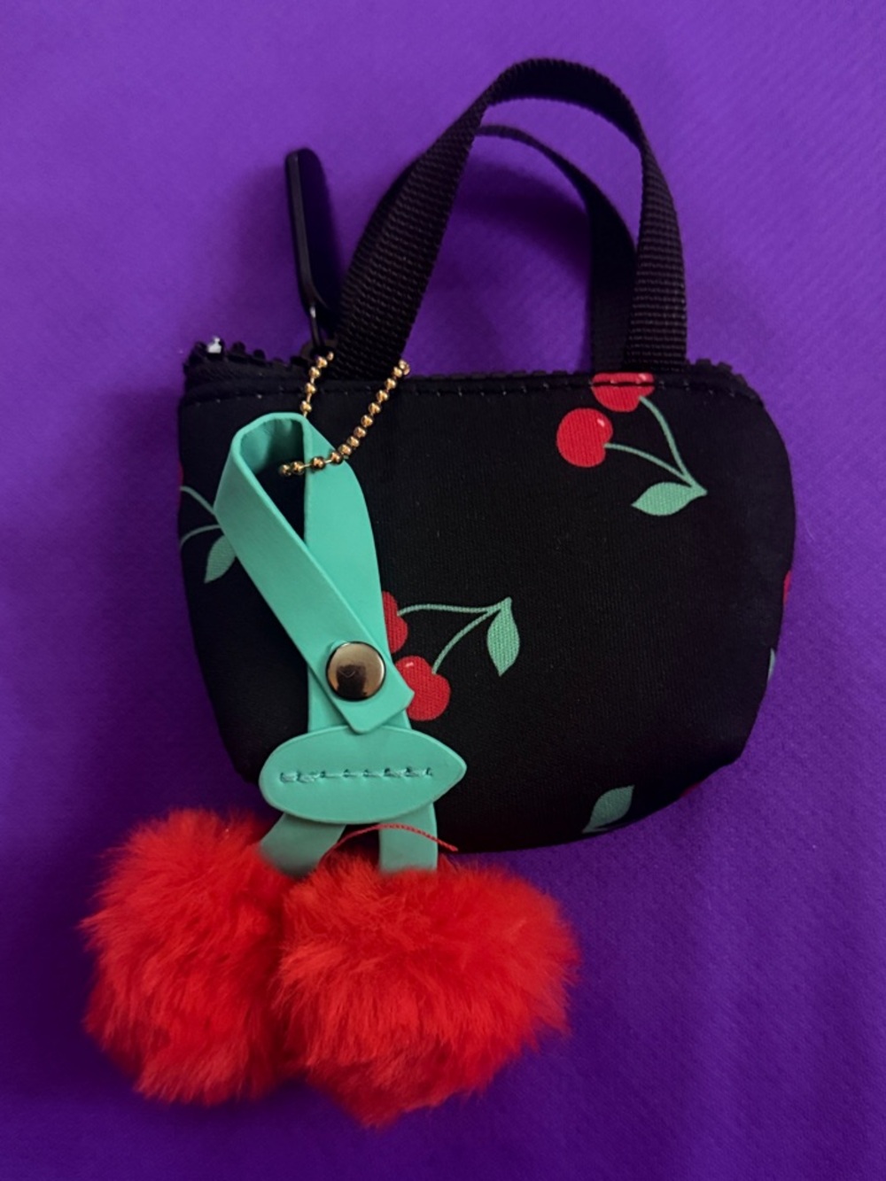 Jessica Simpson Black Mini Bag with Red Cherry Print and Red Pom Pom Charm